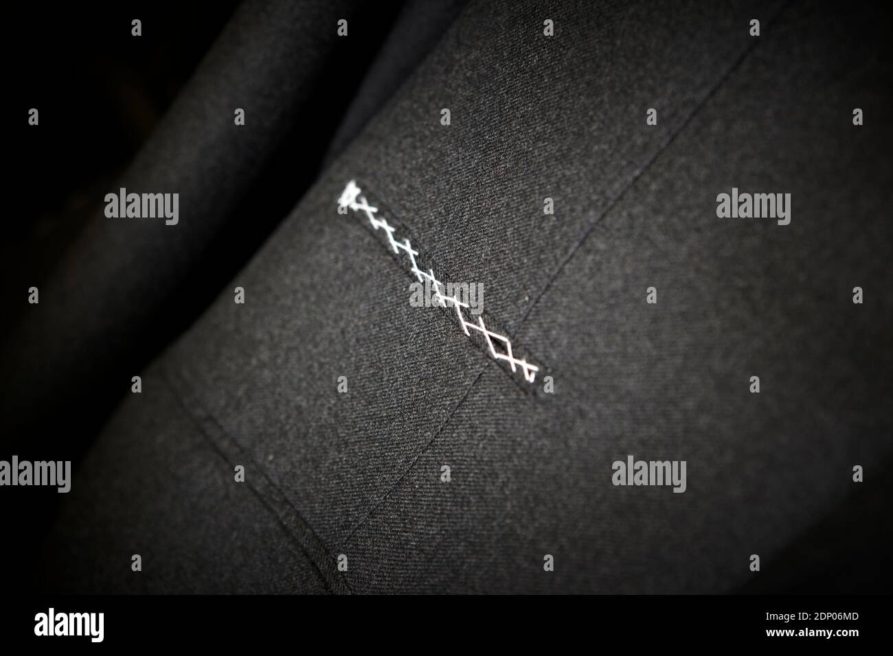 Dark grey suit fabric with sticked pocket. Close up Stock Photo - Alamy