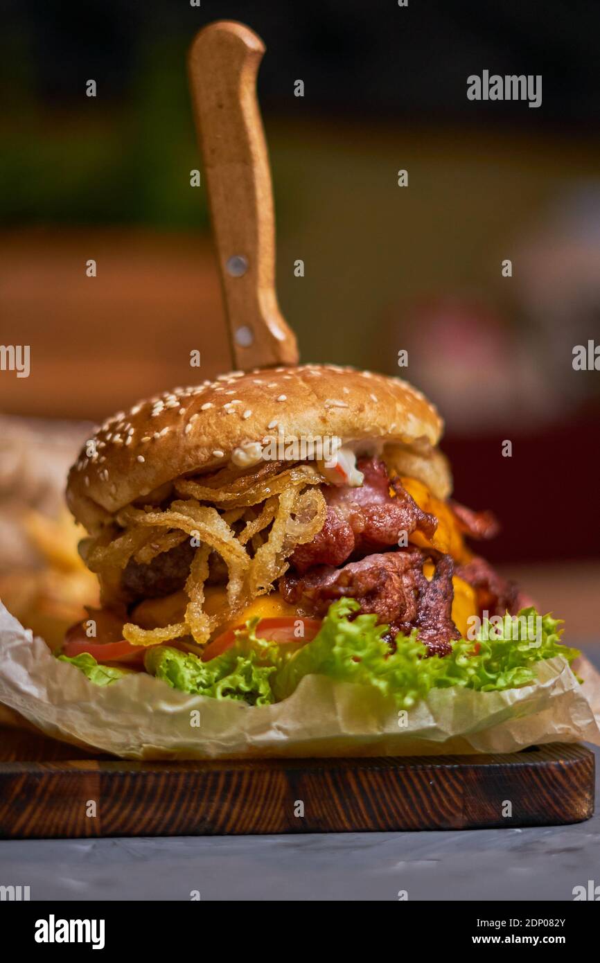 delicious burger with double cutlet on a wooden board Stock Photo