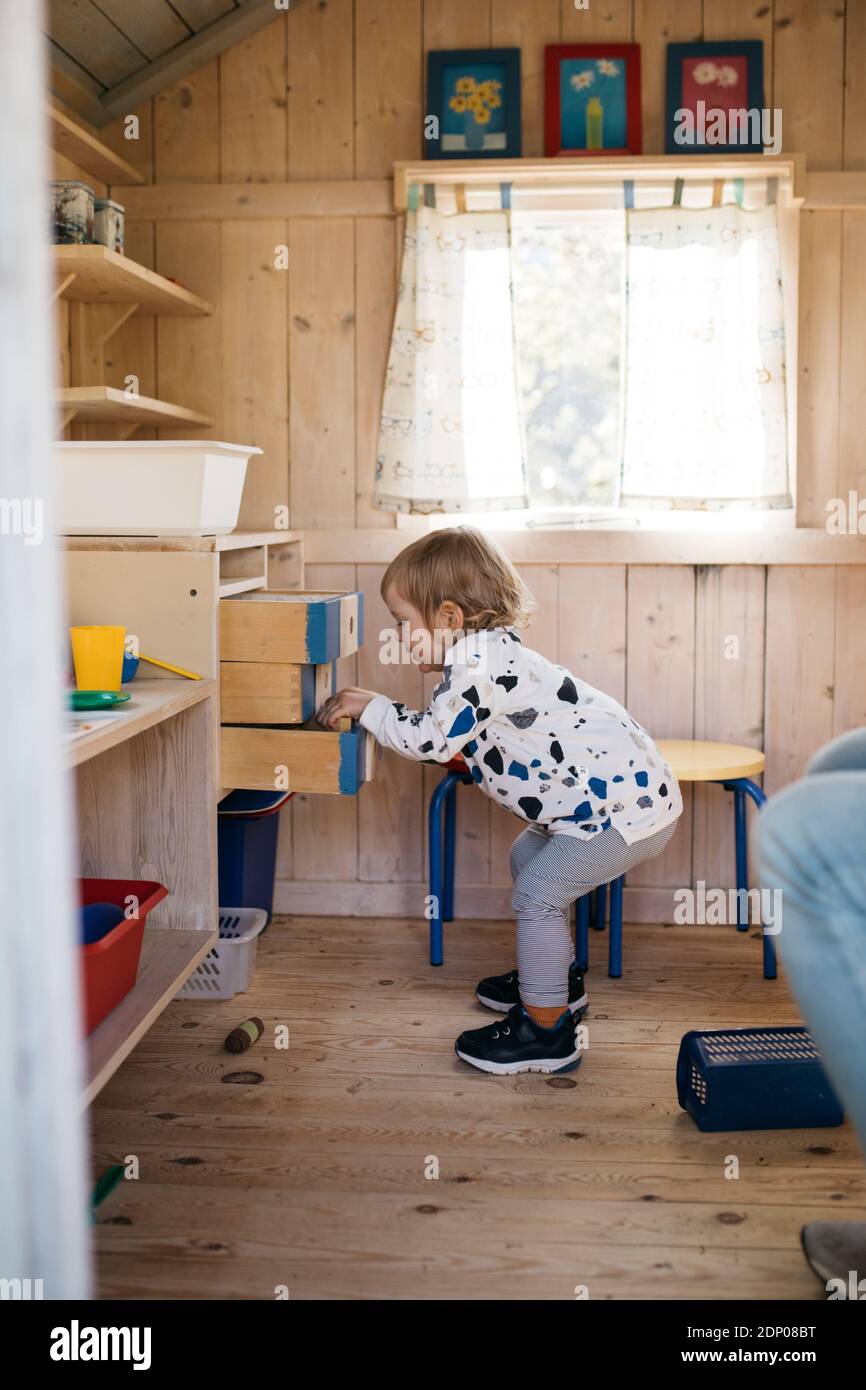 Toddler girl in playhouse Stock Photo Alamy