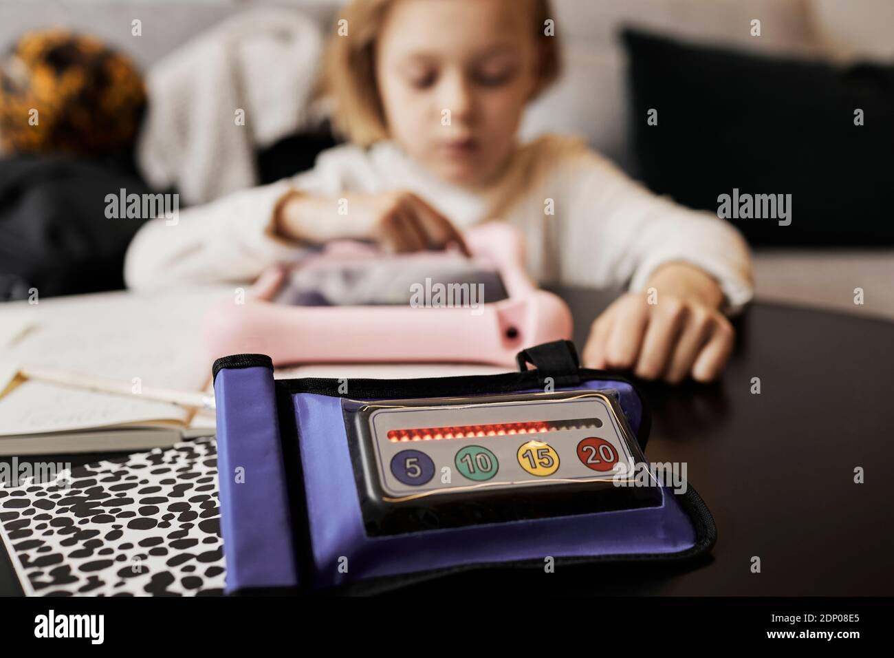 High angle view of educational electronic game, child writing on background Stock Photo