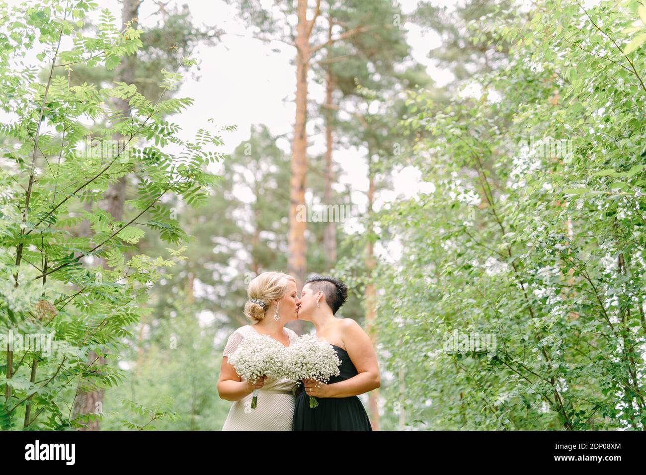 Brides in wedding dresses kissing Stock Photo