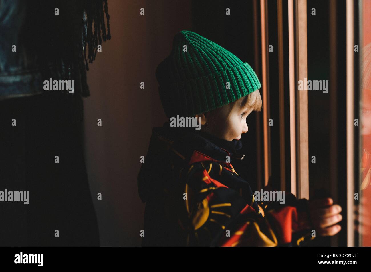 Girl looking through window Stock Photo