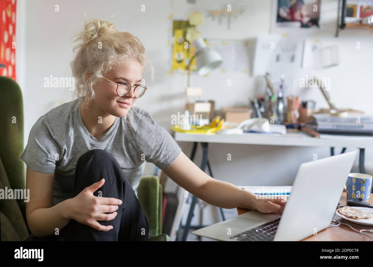 Young woman using laptop at home Stock Photo