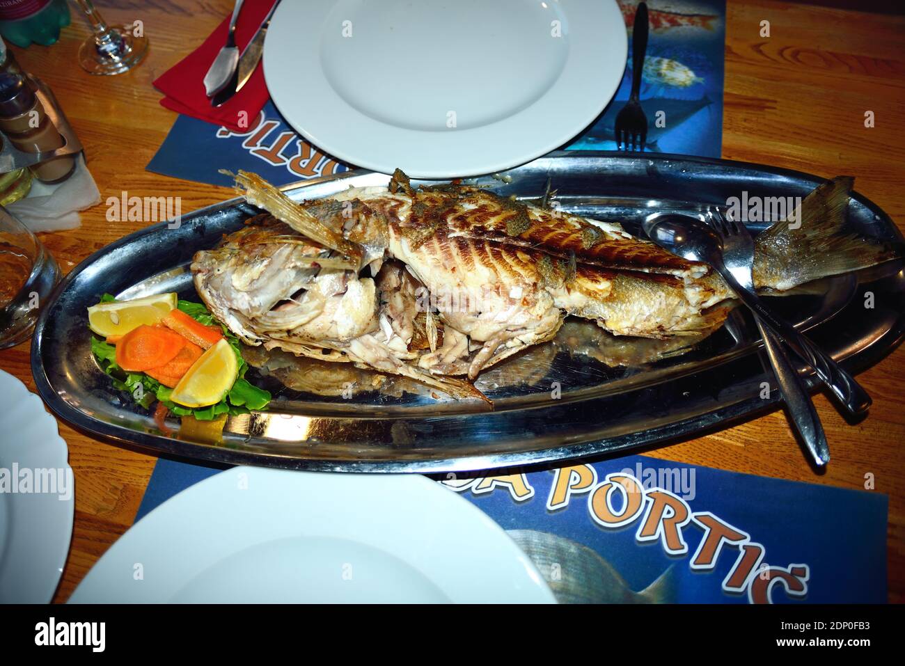Dalmatian coast, Bakarac, Croatia. A grilled common dentex on a table of Konoba Portic restaurant. Stock Photo