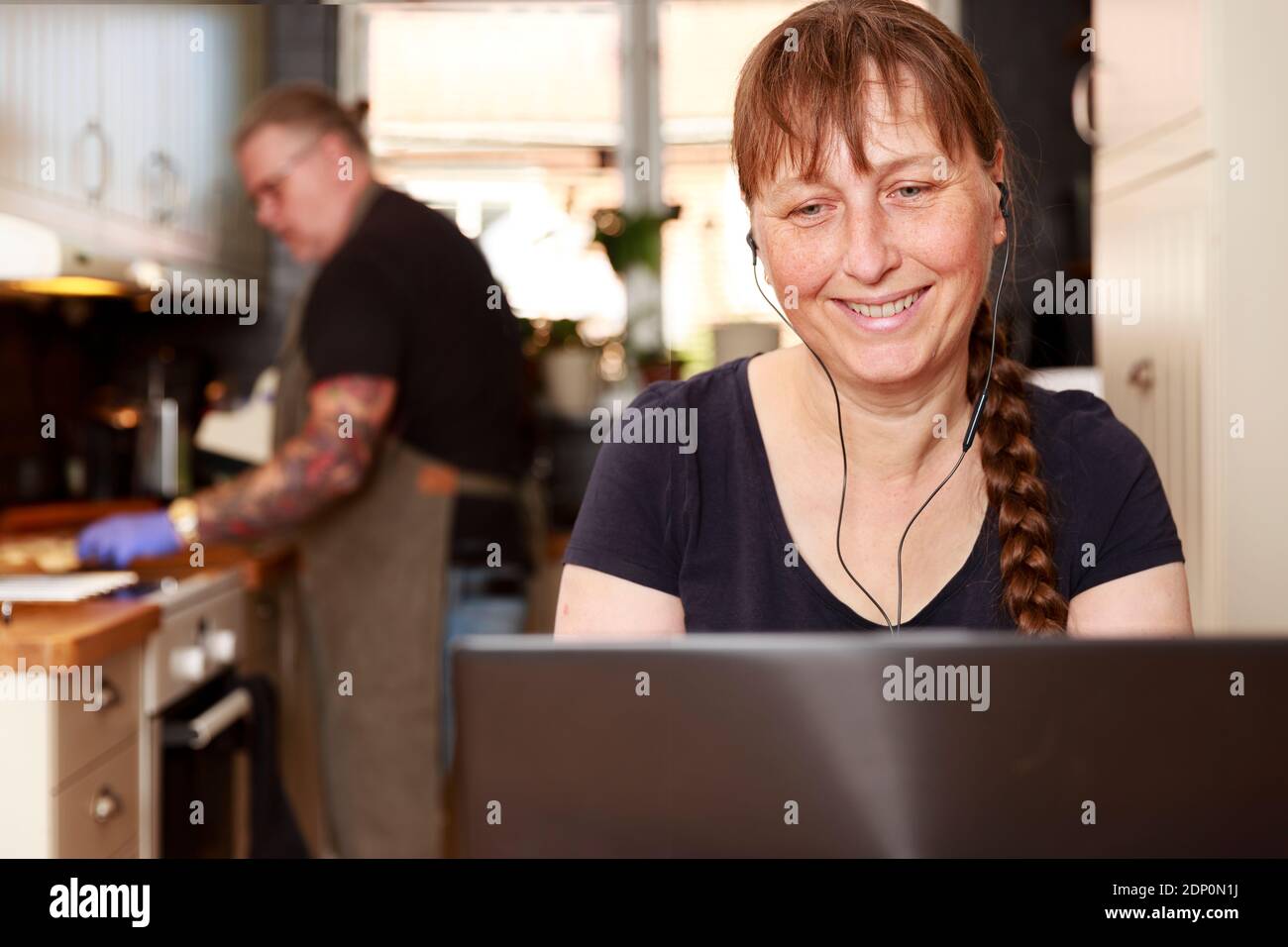 Smiling woman using laptop Stock Photo