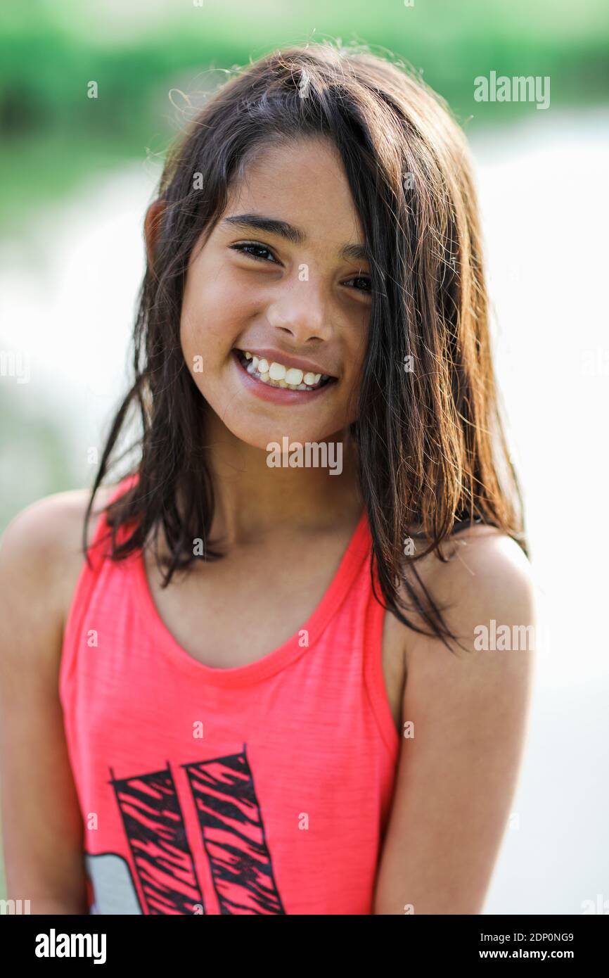 Smiling girl looking at camera Stock Photo - Alamy