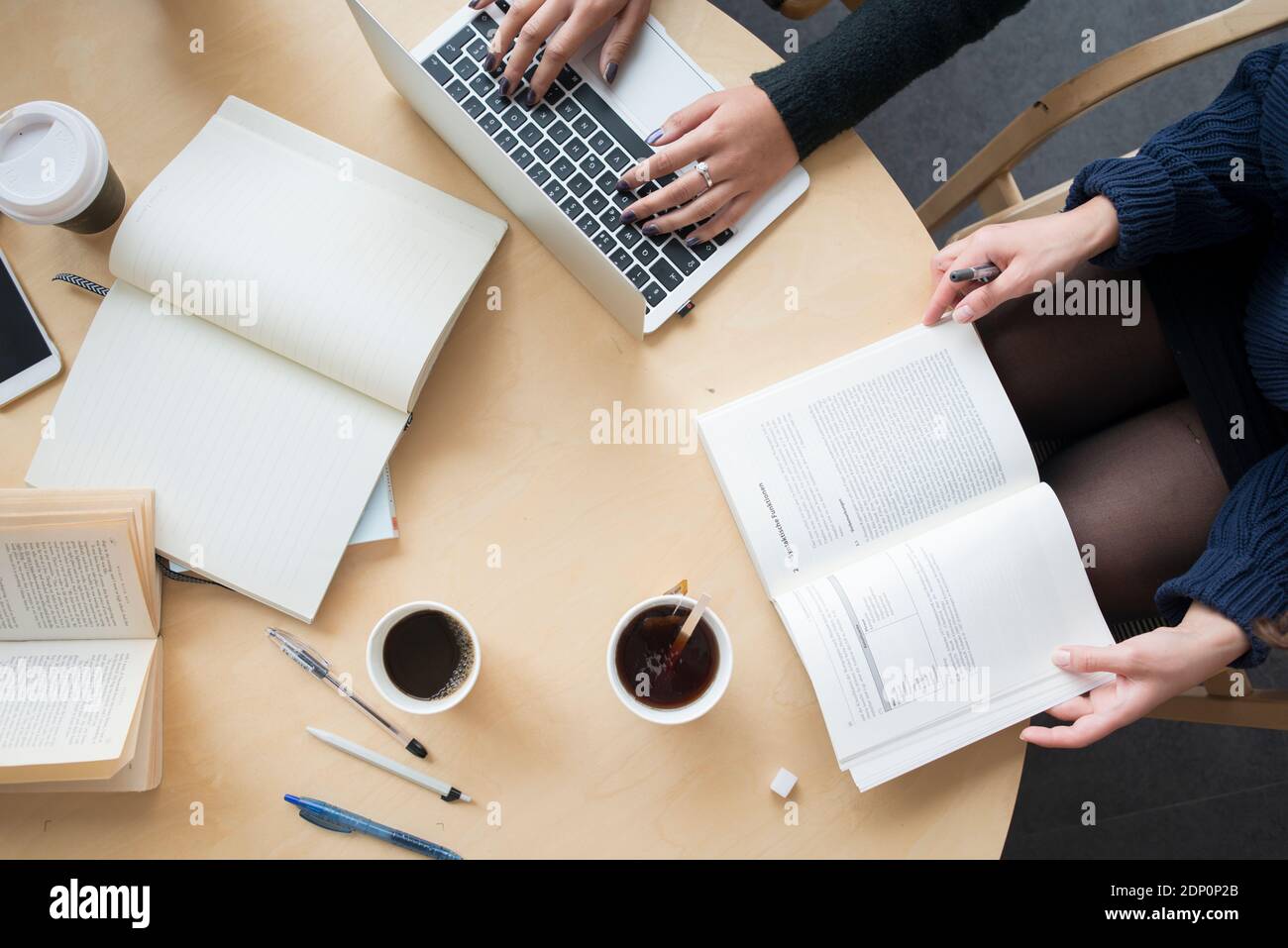 High angle view of people sitting at table in library Stock Photo