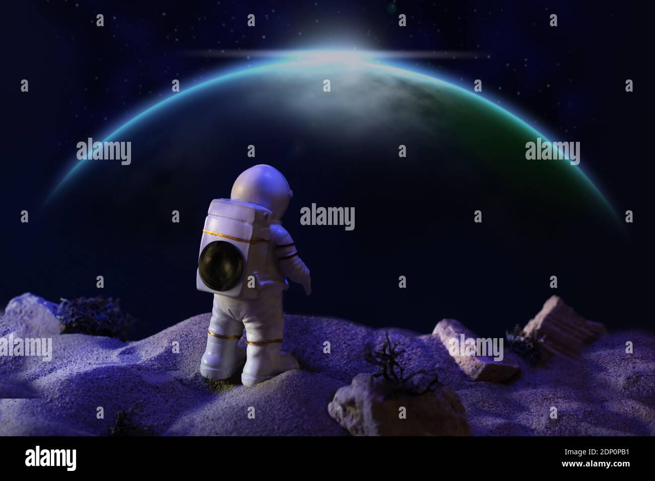 Astronaut in a space suit looking at galaxy. Space travel concept. Stock Photo