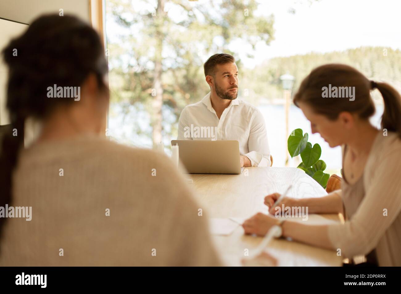 Man at table looking away Stock Photo