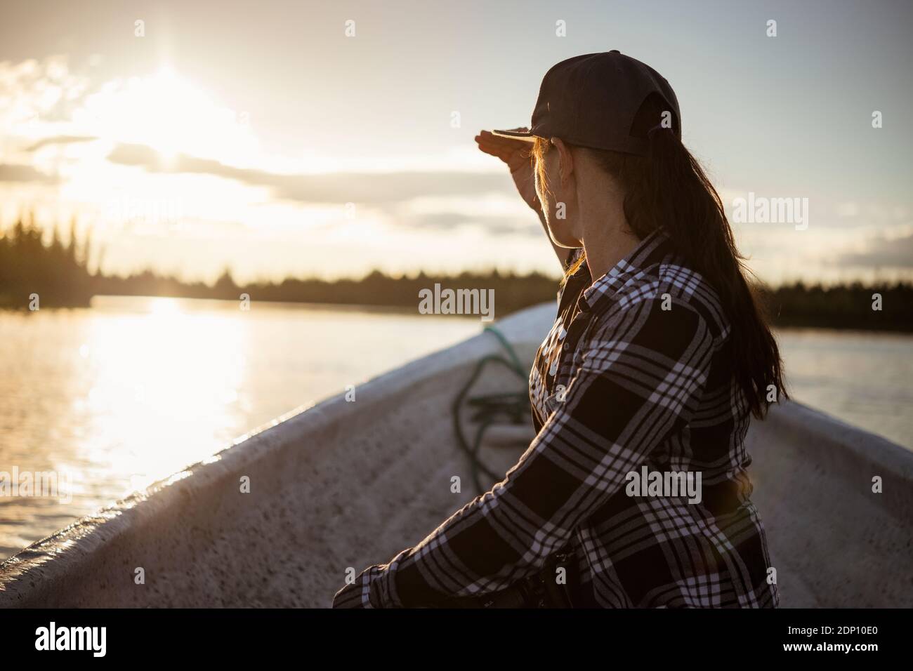 Woman on boat looking at lake Stock Photo - Alamy