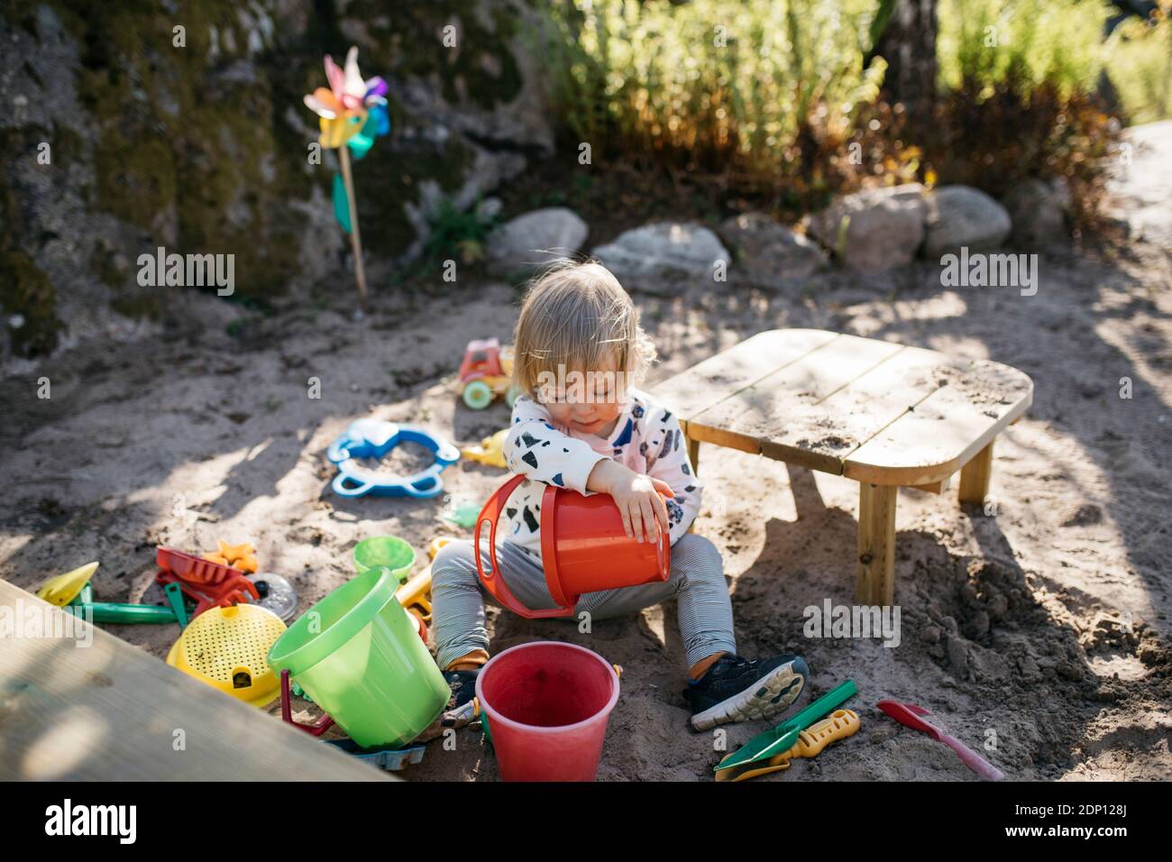 Girl playing in sandpit Stock Photo