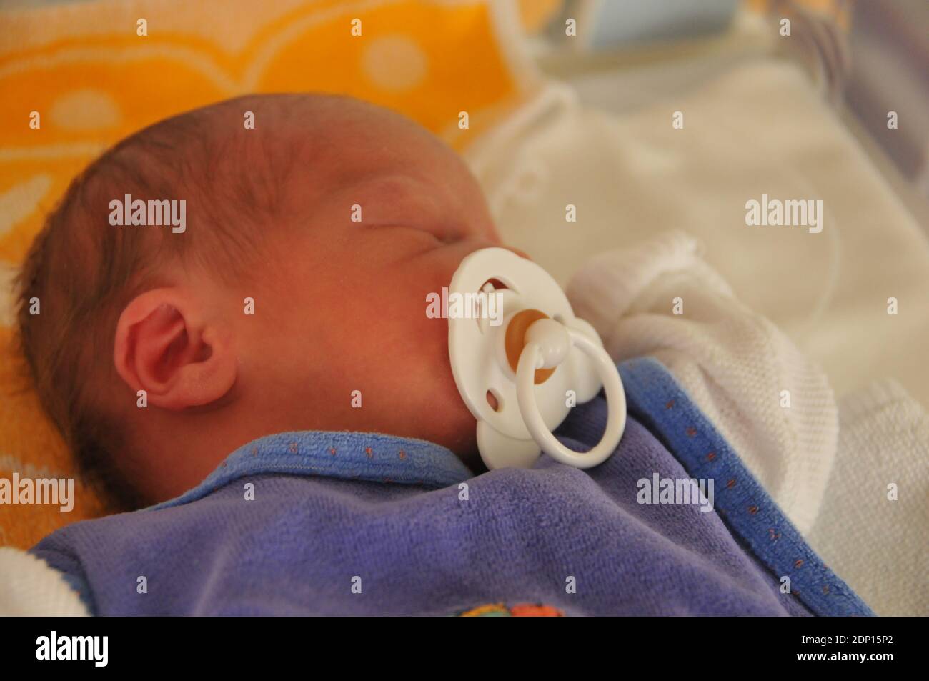 Sleeping baby with large dummy Stock Photo Alamy