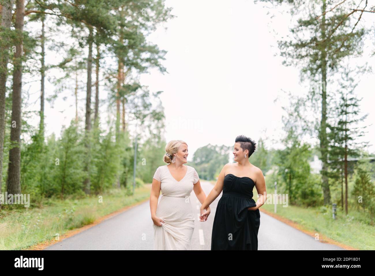 Brides in wedding dresses walking together Stock Photo