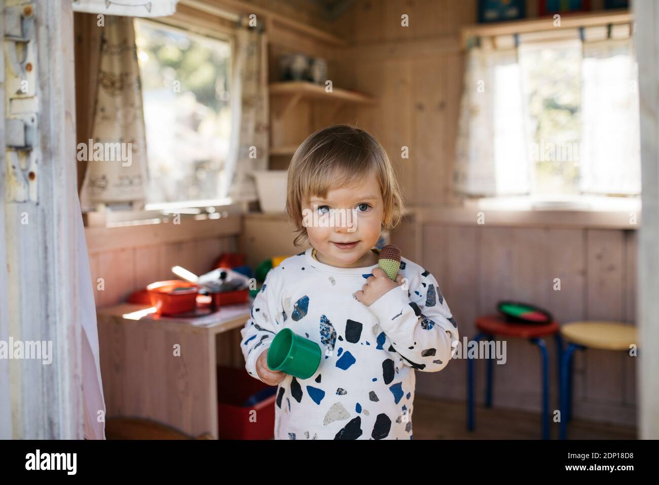 Toddler girl in playhouse Stock Photo Alamy