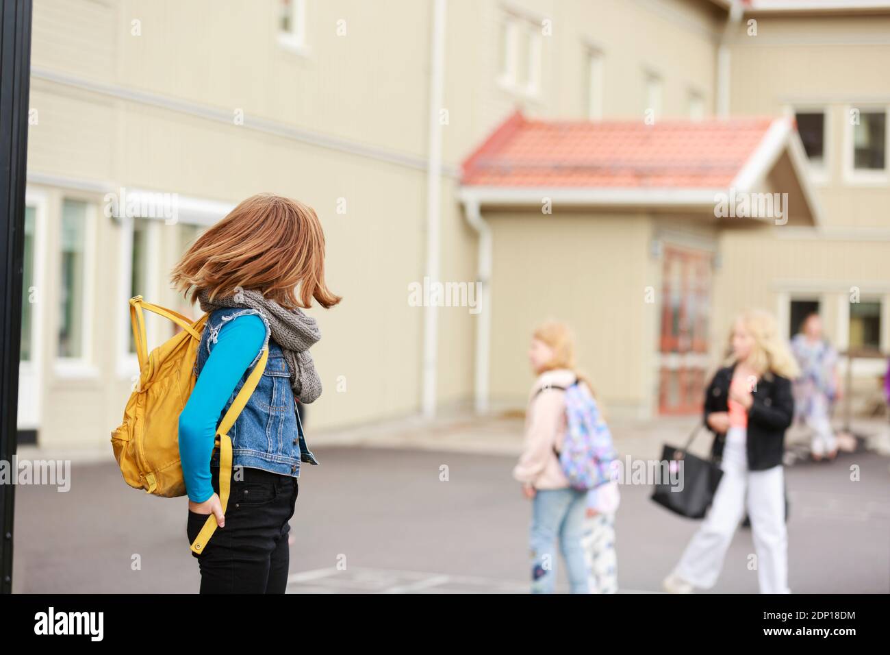 Girl in front of school building Stock Photo - Alamy