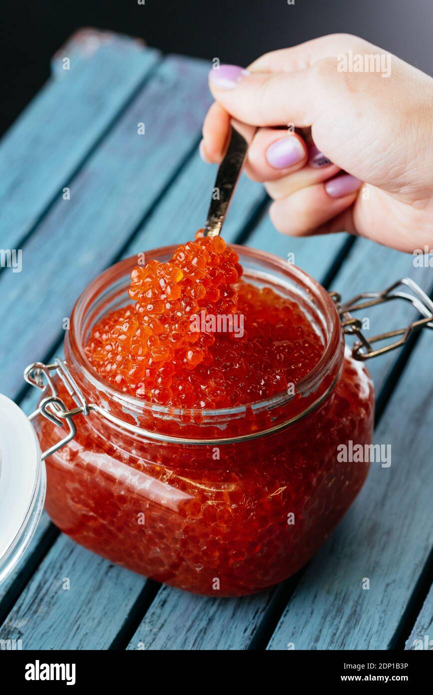 red caviar in a jar with a spoon Stock Photo