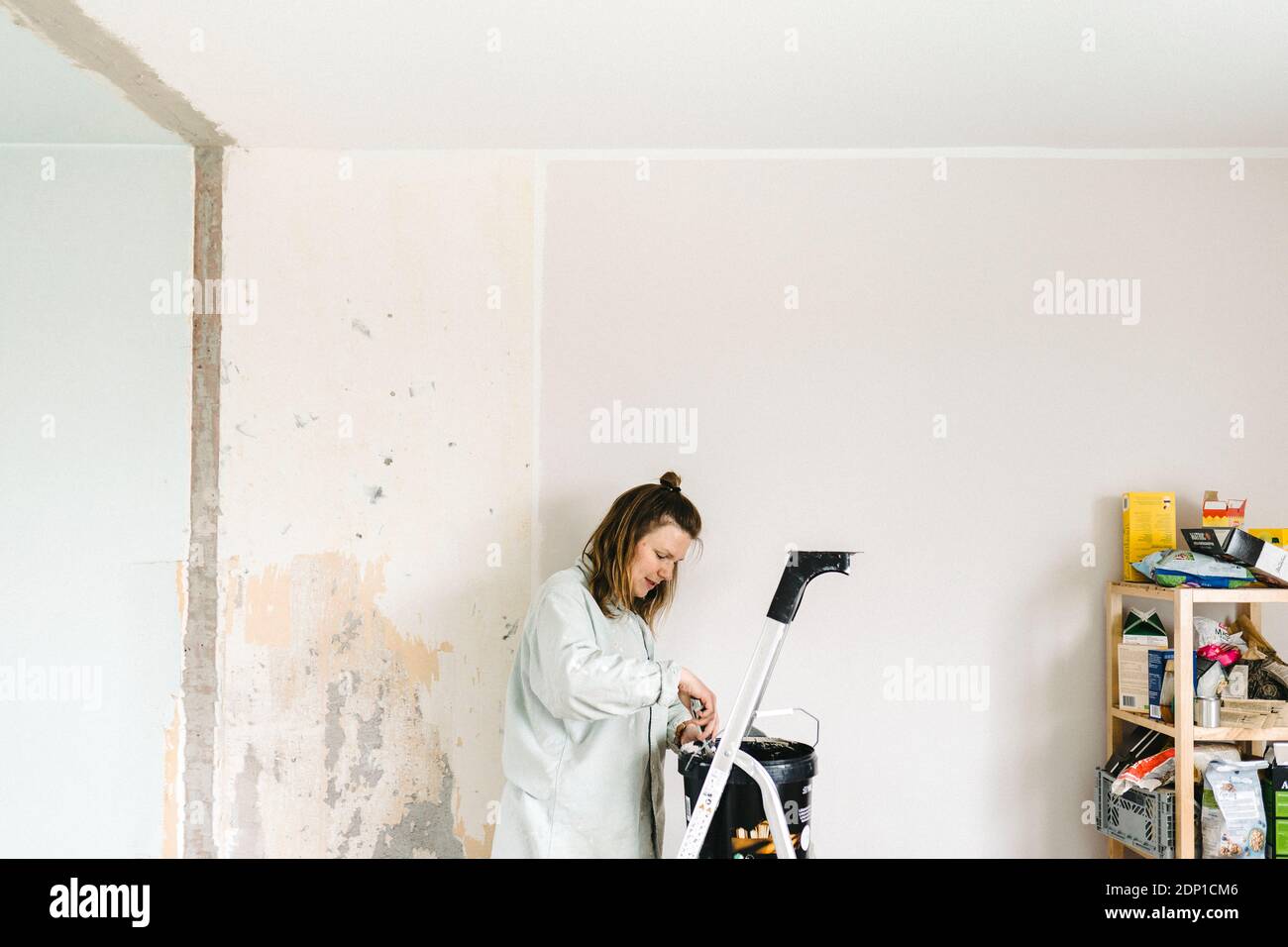 Woman renovating room Stock Photo