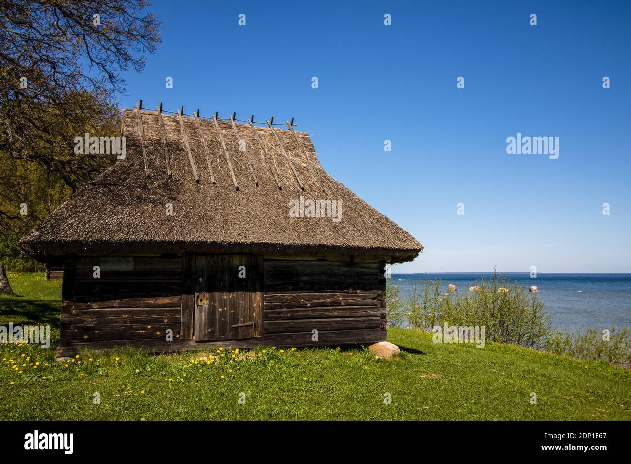 Old wooden fishermen's hut near baltic sea, during sunny day, with blue sky, Estonian open air museum, Tallinn Stock Photo