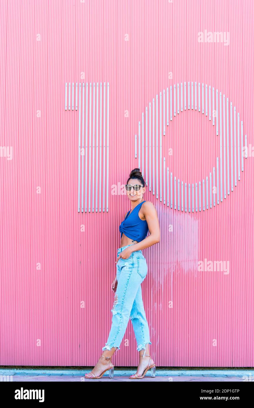 Woman wearing pink top jeans hi-res stock photography and images - Alamy