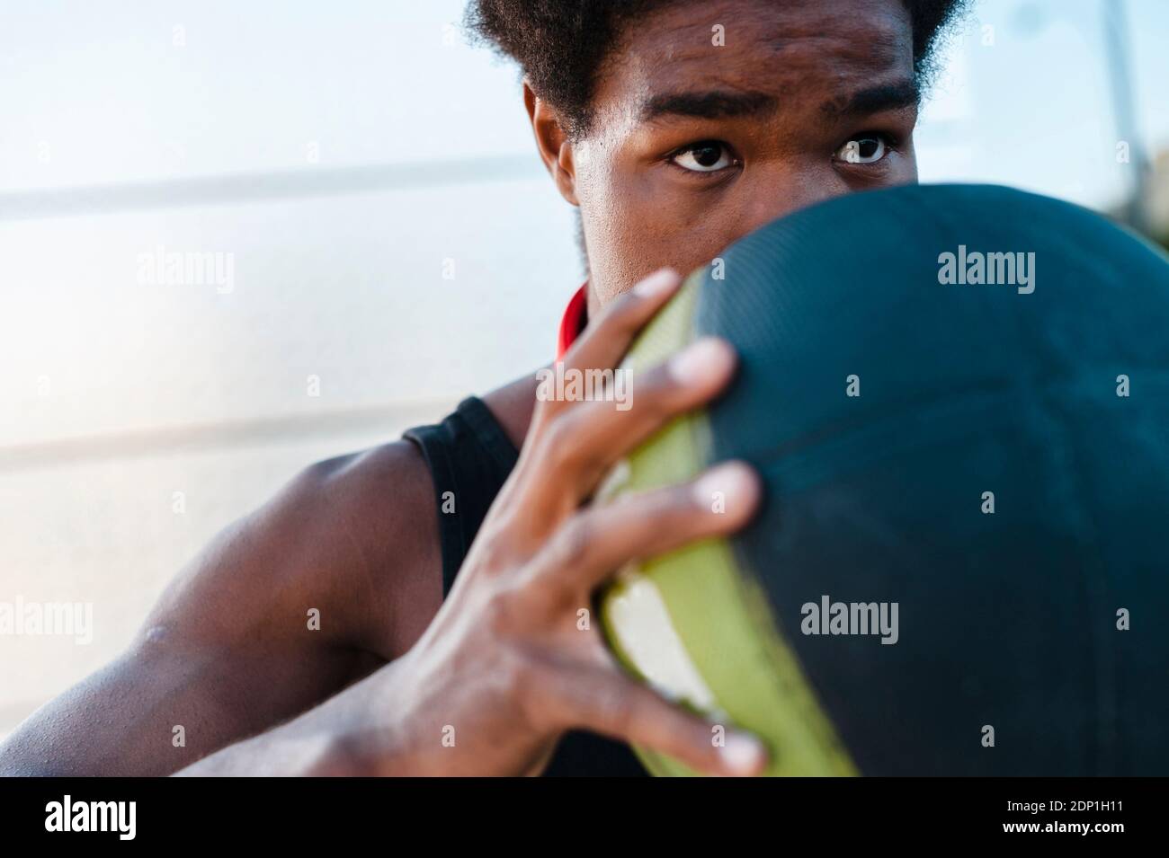 Close-up of a young man holding basketball Stock Photo
