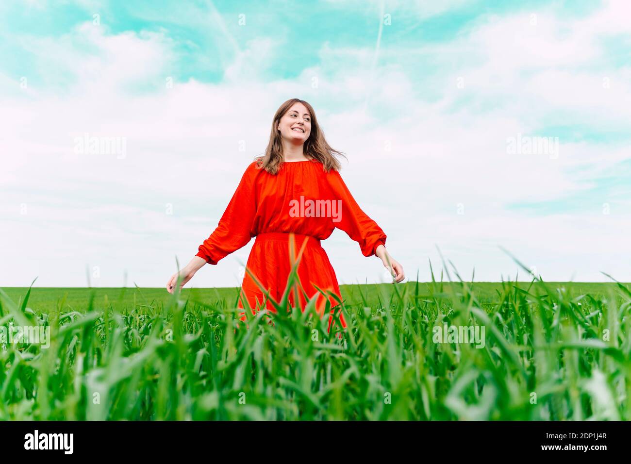 Woman in red dress smiling hi-res stock photography and images - Alamy