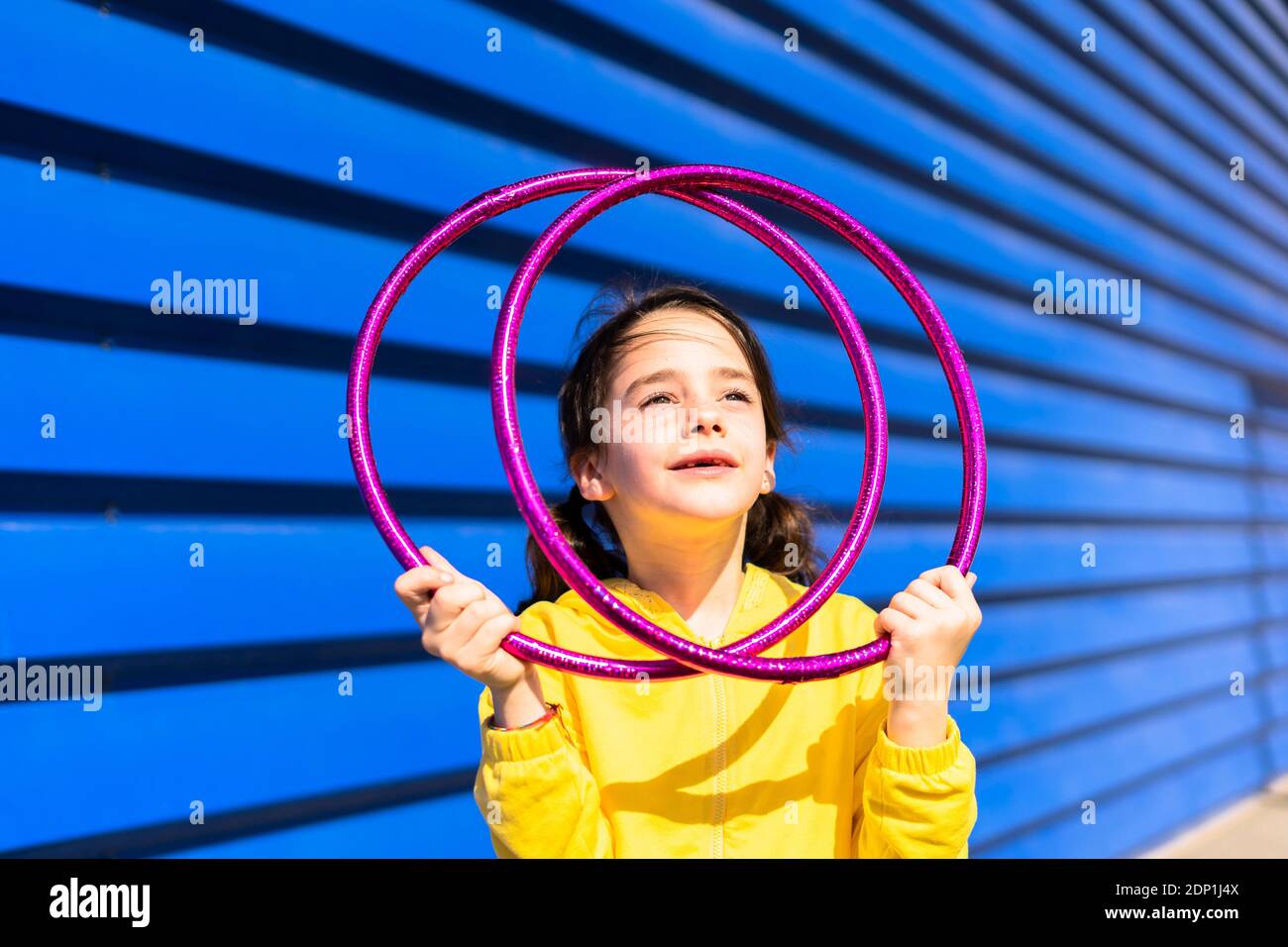 Portrait of little girl with gymnastic rings looking up Stock Photo Alamy