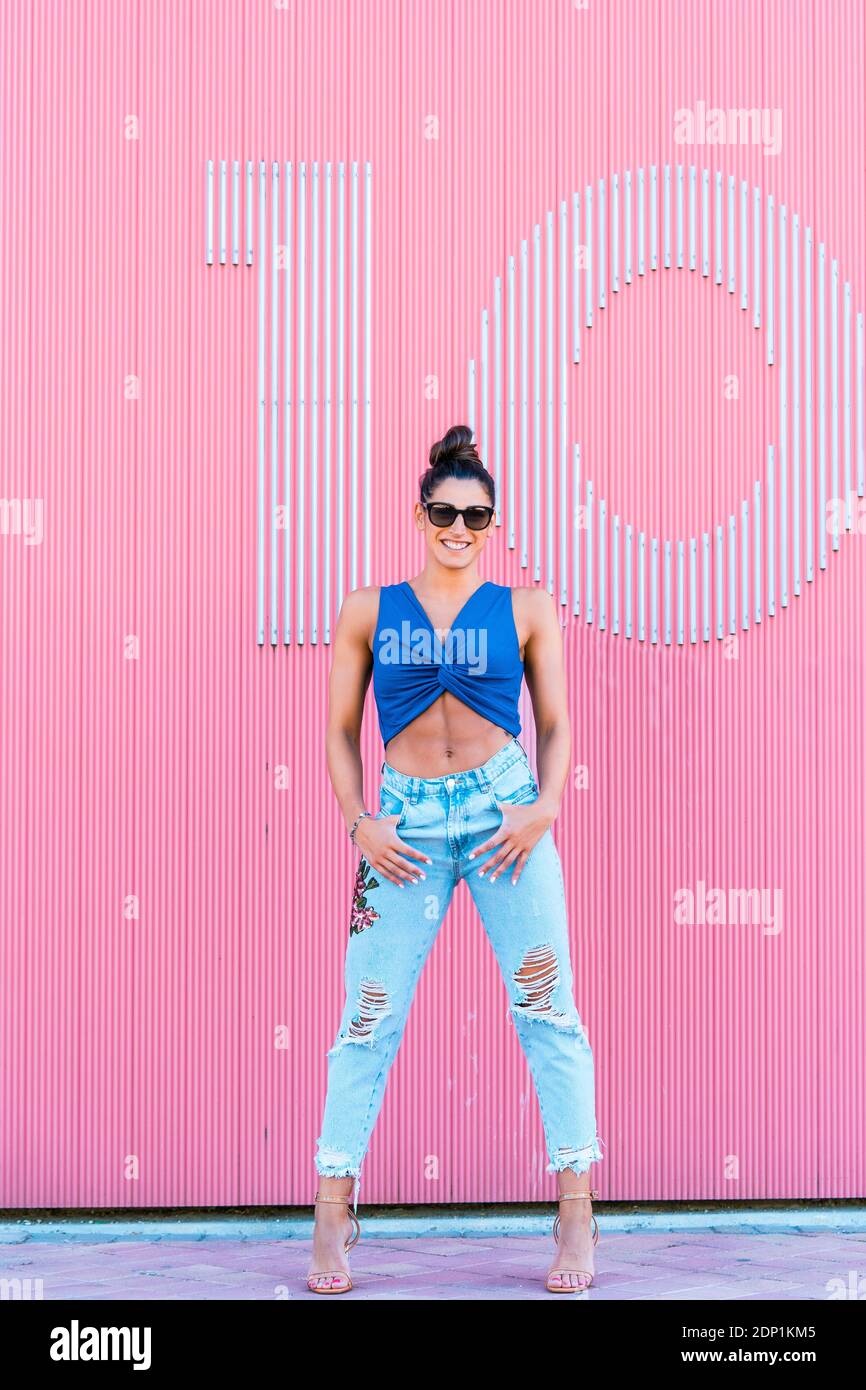 Woman wearing pink top jeans hi-res stock photography and images - Alamy