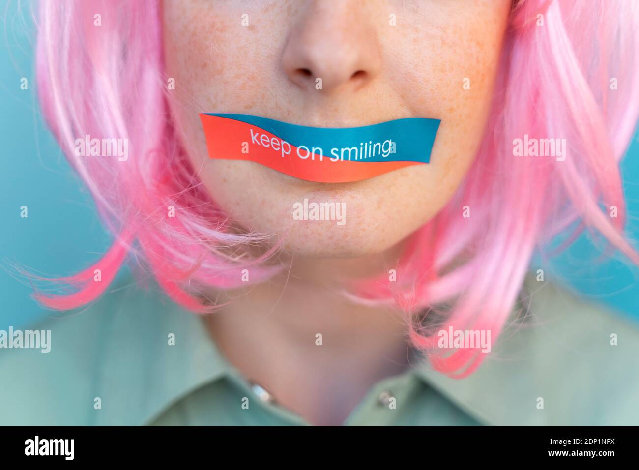 Detail of young woman with taped mouth Stock Photo