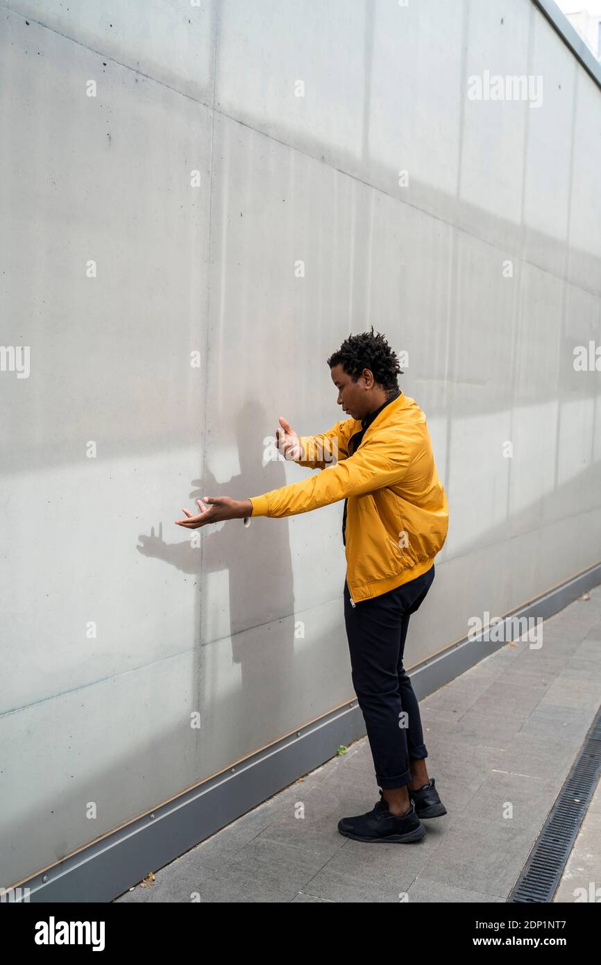 Mature man performing in front of a wall Stock Photo