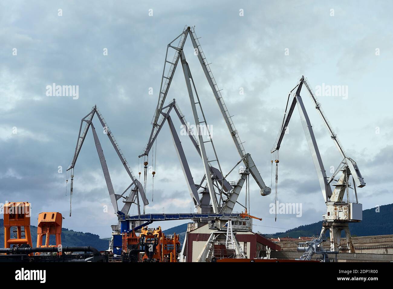 Cranes in the shipyard over cloudy sky Stock Photo - Alamy