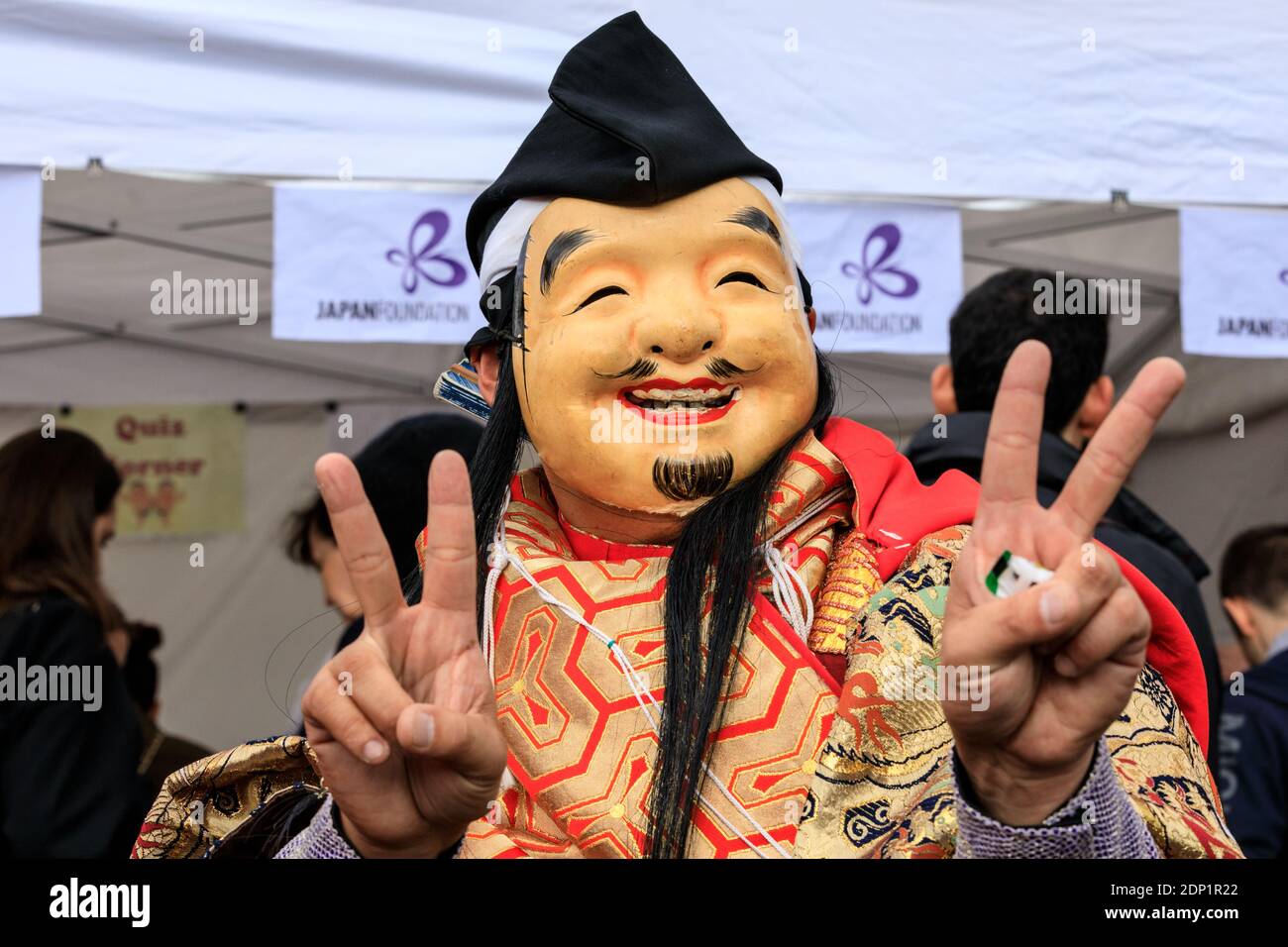 Participant in Asian mask at Japan Matsuri Festival on Trafalgar Square, London, UK Stock Photo