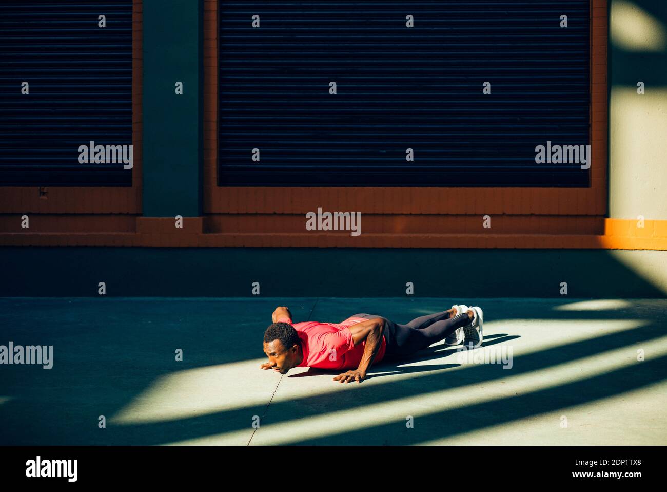 Young sportive man doing pushups outdoors Stock Photo