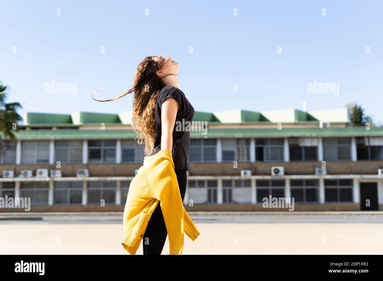 Happy teenage girl standing outdoors Stock Photo