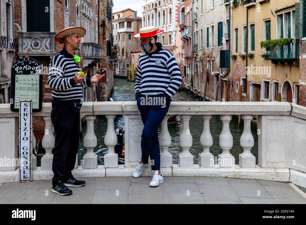 Two Gondoliers Wait For Customers, Venice, Italy. Stock Photo