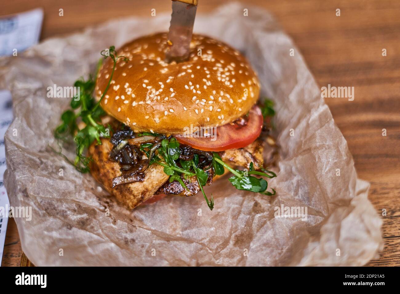 delicious chicken burger On paper and wooden board Stock Photo