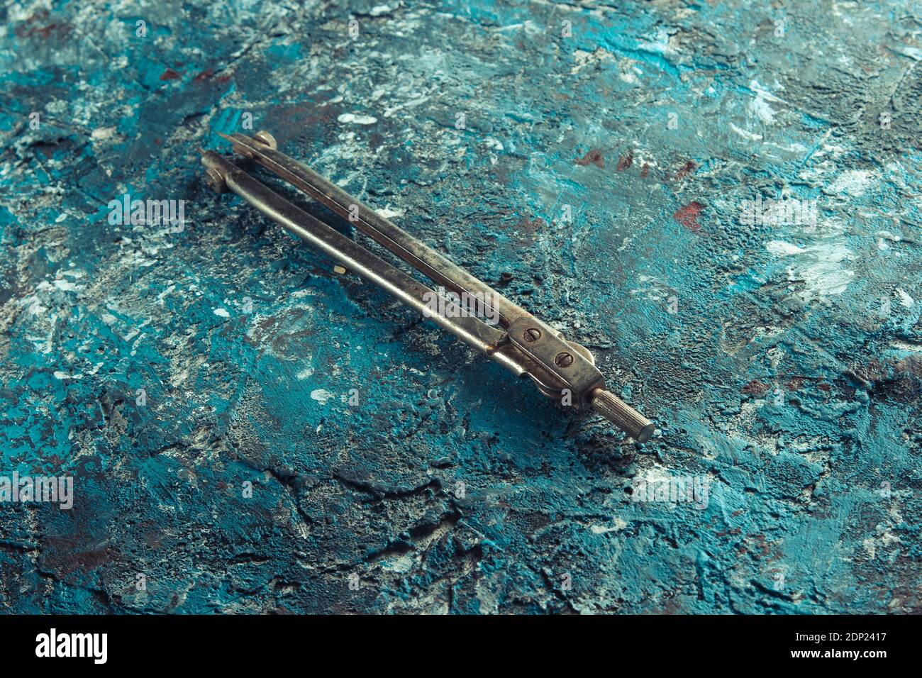 Old compass drawing on a blue concrete background Stock Photo