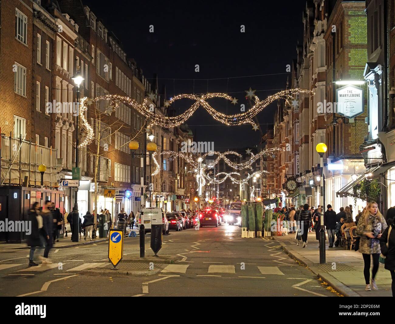 View looking up at the festive Christmas decorations at night in Marylebone High Street London 2020 Stock Photo