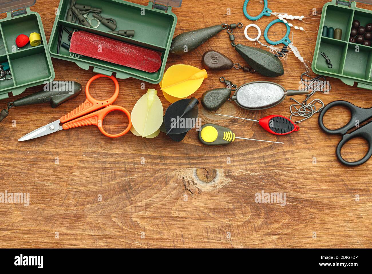Vintage fishing tackle on old wood and black background Stock