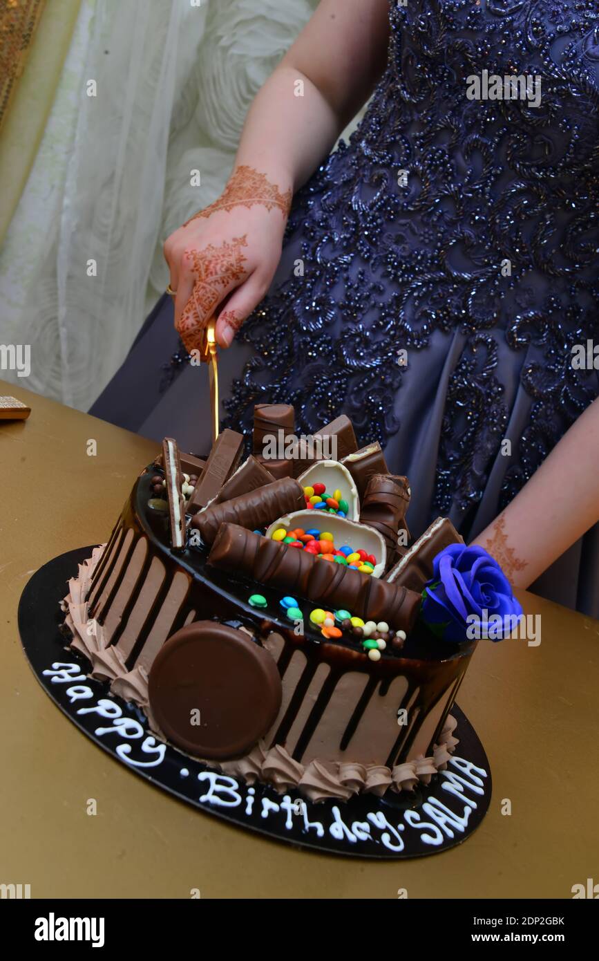 Black birthday cake with chocolate sticks. Classic birthday Stock Photo -  Alamy
