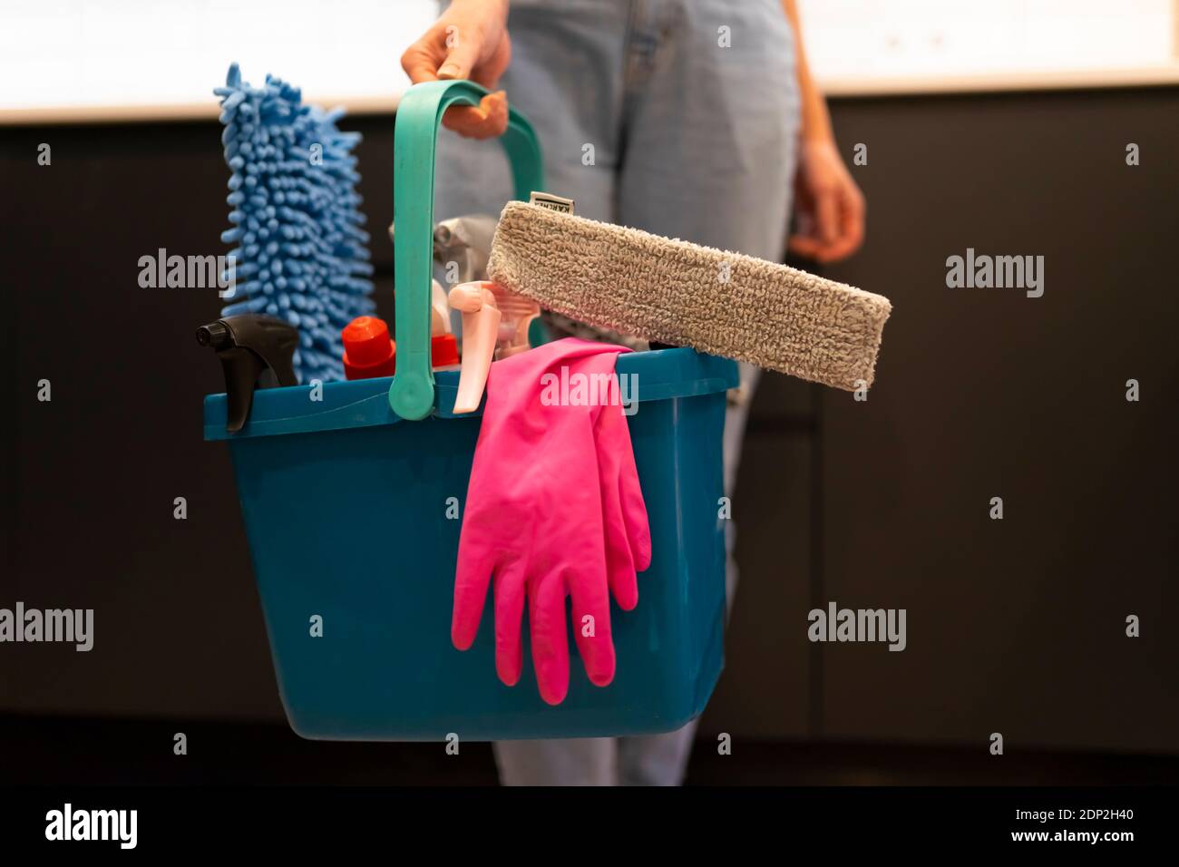 Woman holding plastic bucket with cleaning products Stock Photo - Alamy