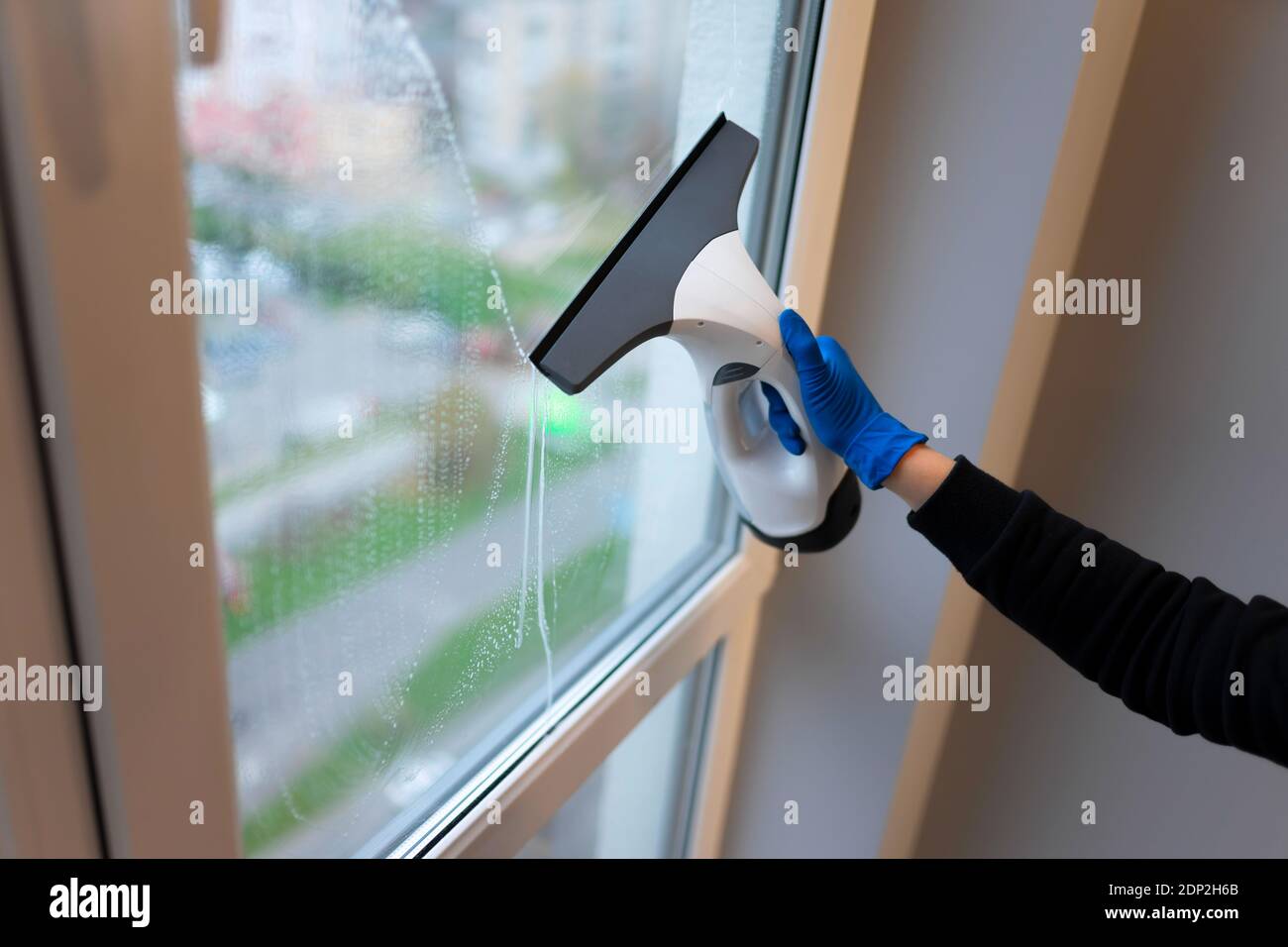 Window cleaning with electric vacuum cleaner. Clean windows concept