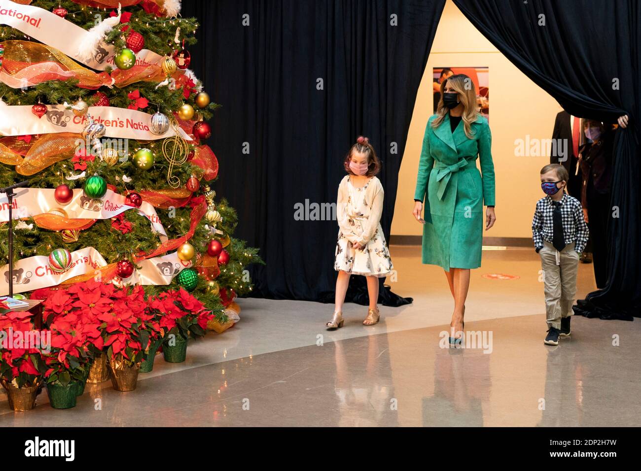 Washington, United States Of America. 15th Dec, 2020. U.S. First Lady Melania Trump walks with 8 year-old patient Sofia Martinez and 6 year-old patient Riley Whitney during a Christmas visit to Children's National Hospital December 15, 2020 in Washington, DC Credit: Planetpix/Alamy Live News Stock Photo