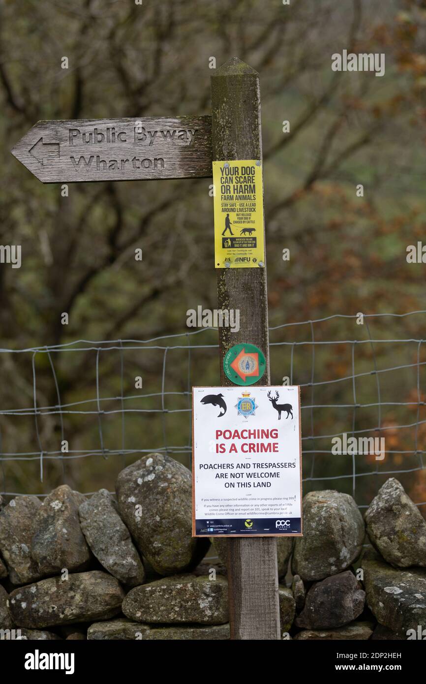 Sign on a footpath warning against poaching and trespassing on land in the countryside. Yorkshire Dales, UK. Stock Photo