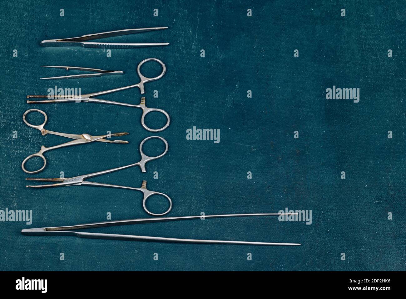 Old, rusty, used surgical instruments on a blue background, close up Stock Photo