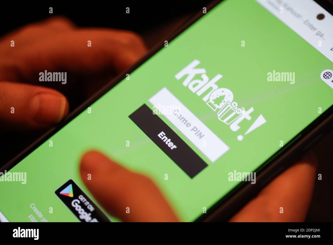 Bucharest, Romania - December 18, 2020: Shallow depth of field details with the hands of a woman using the Kahoot website/app on a mobile device. Stock Photo