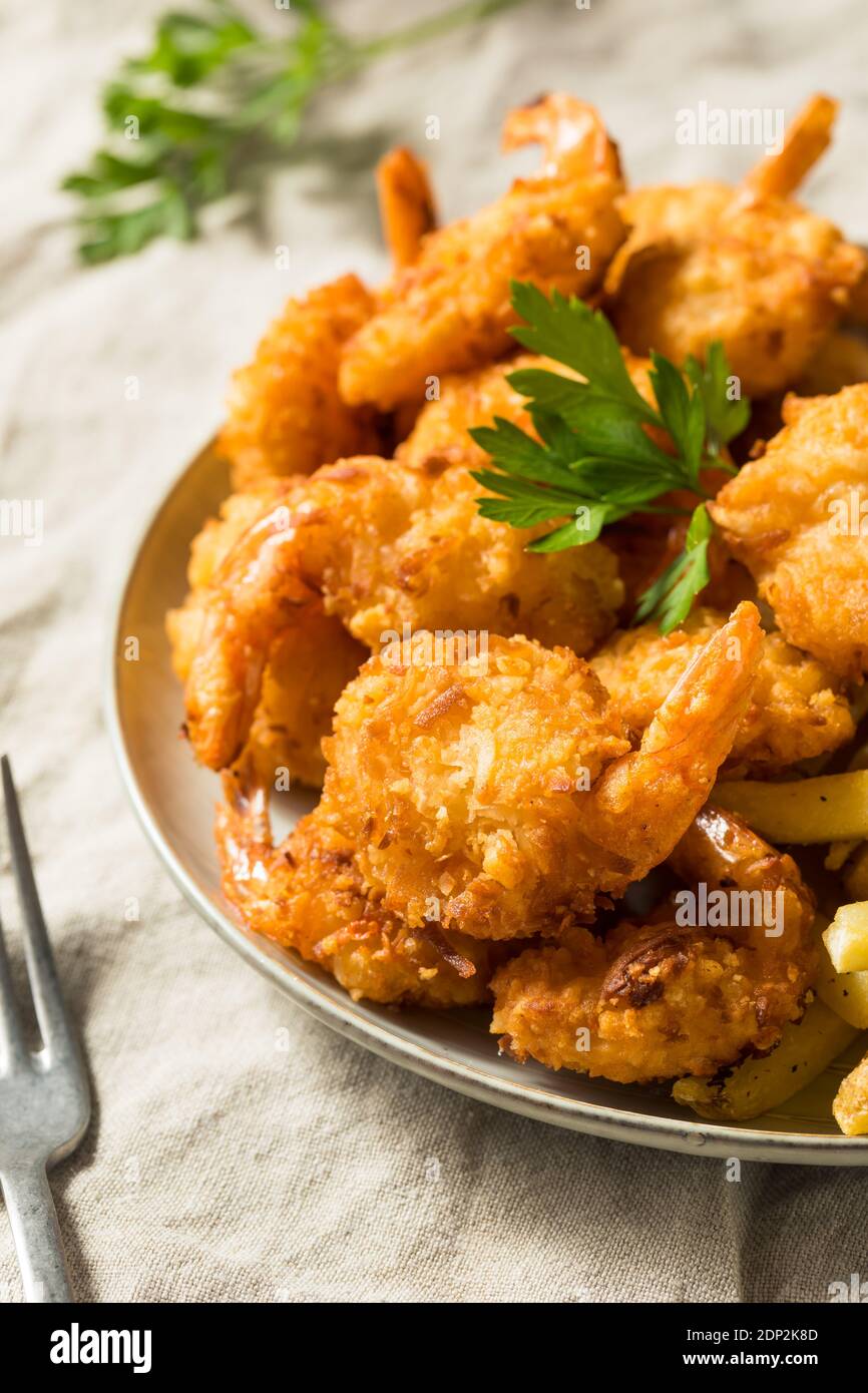 Homemade Deep Fried Coconut Shrimp with Fries and Cocktail Sauce Stock Photo