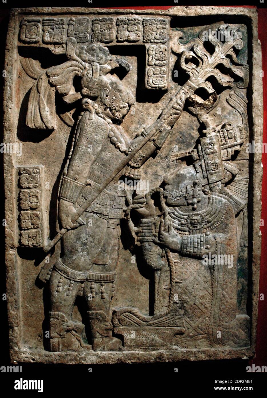 The Yaxchilan Lintels. Lintel 24. Structure 23. Carved limestone lintel. Depiction of a bloodletting ritual performed by the king of Yaxchilan, Shield Jaguar II and his wife, Lady K'ab'al Xook. The king holds a flaming torch over his wife, who is pulling a thorny rope through her tongue. Scrolls of blood can be seen around her mouth. Classic Maya. 723-726. Limestone. Yaxchilan, Chiapas, Mexico. British Museum. London, England, United Kingdom. Stock Photo