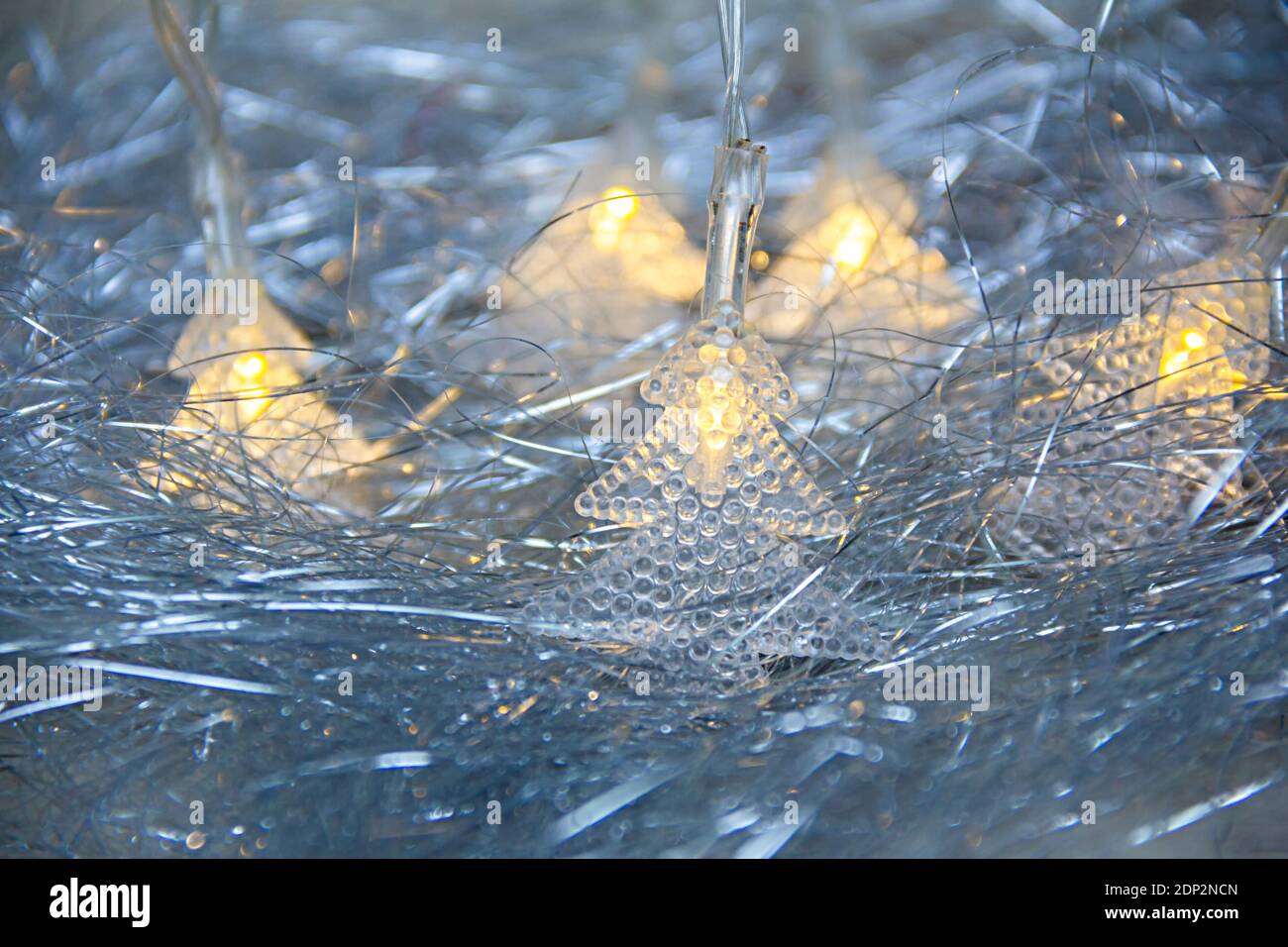 Christmas tinsel and electric fir tree shaped garland light on a white
