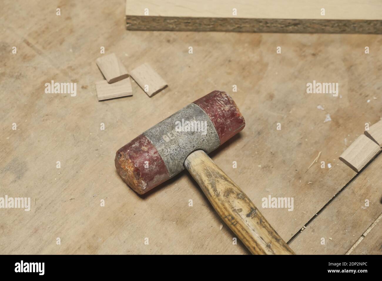 Hammer on wooden workshop table. High angle view. Stock Photo