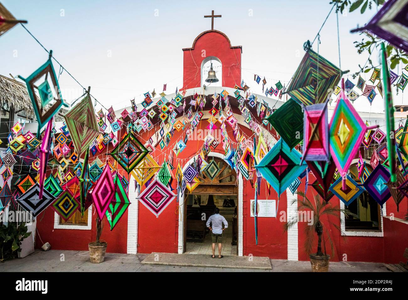 The main church in Sayulita, Nayarit, Mexico decorated outside with Ojo de Dios or 'God's Eye', a local symbol and craft of the indigenous Huichol cul Stock Photo